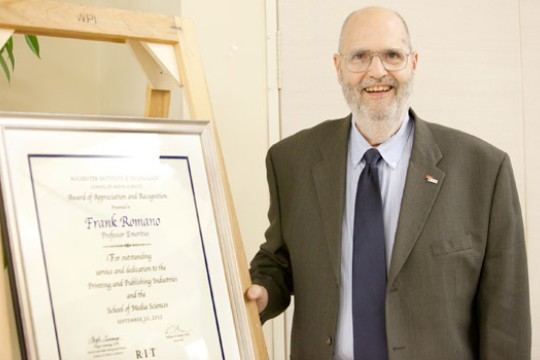 Person posing with award