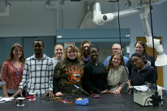 People posing in classroom