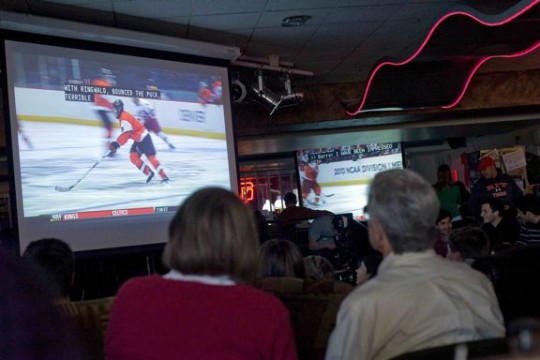 People gathered watching hockey 