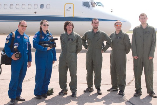 People posing near space shuttle