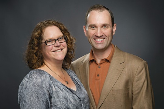 Two people posing for camera