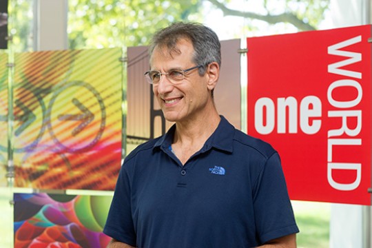 Person posing on stage during event