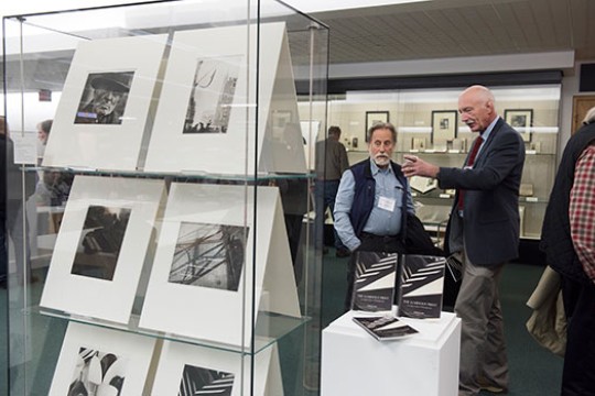 Two people looking at photography exhibit.