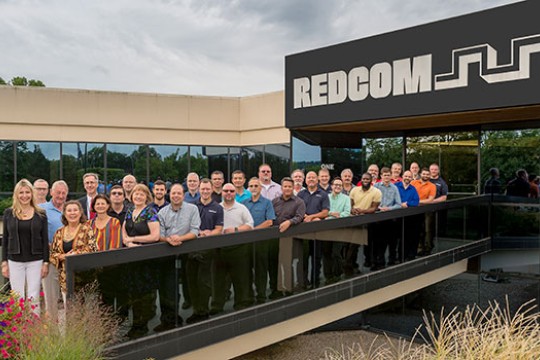 Members of REDCOM and RIT pose for a group photo outside the REDCOM office.