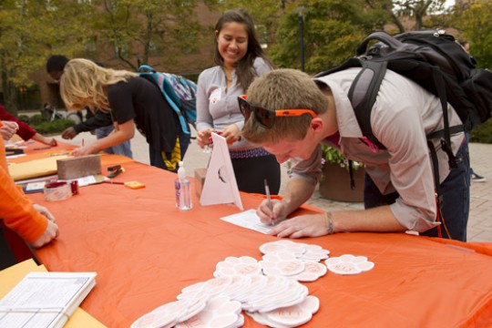 People signing documents at table