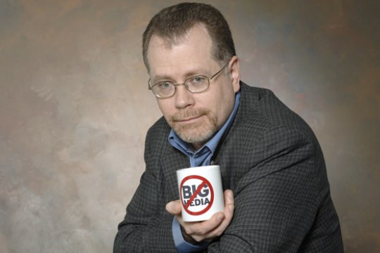 Person holding mug posing for camera