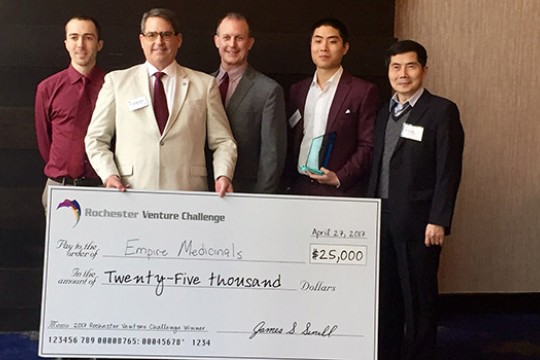 People posing with giant check