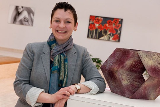 Tabitha Jacques posing next to a sculpture in the Dyer gallery.