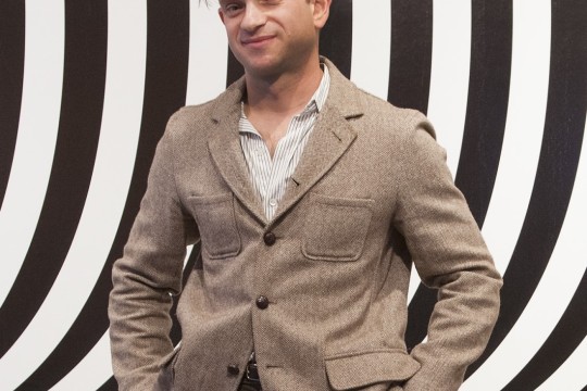 Snyderman stanging infront a wavy background