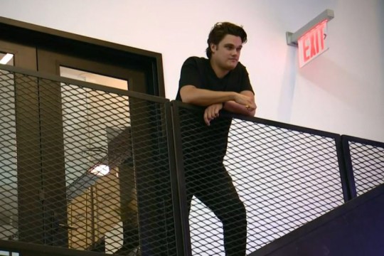 Man stands at top of stairwell.