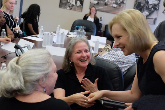 three women meeting and shaking hands.