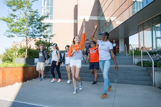 two students high-fiving.