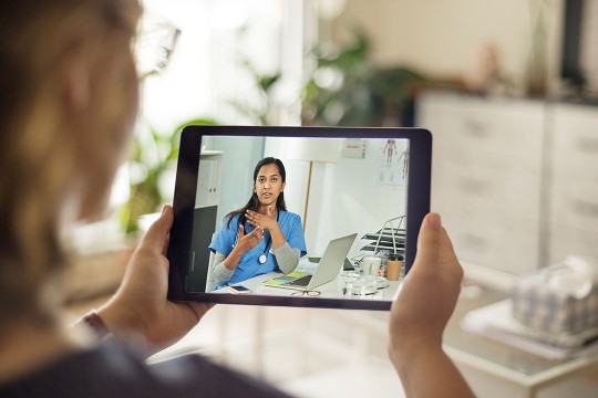 patient listening to doctor from a tablet.