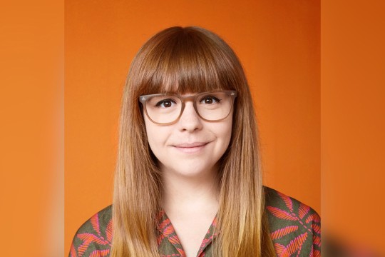 A headshot of Justine Raymond.