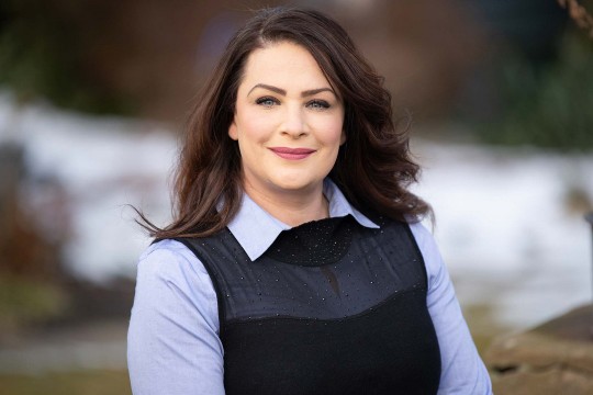 Woman in blue shirt smiles