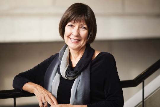 a headshot of Pattie Moore standing on stairs
