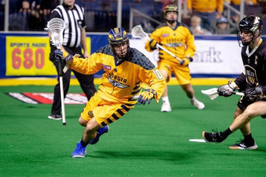 Alex Crepinsek is shown in a yellow Lacrosse uniform playing for the Georgia Swarm.