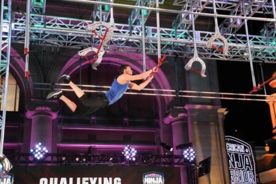 Kyle Schulze leaps through the American Ninja Warrior course on television.