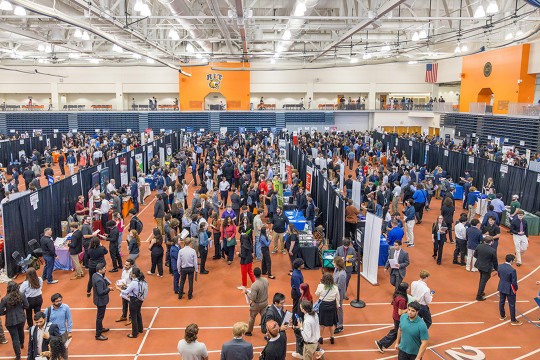 a birds eye view of the R I T gymnasium full of people attending a career fair