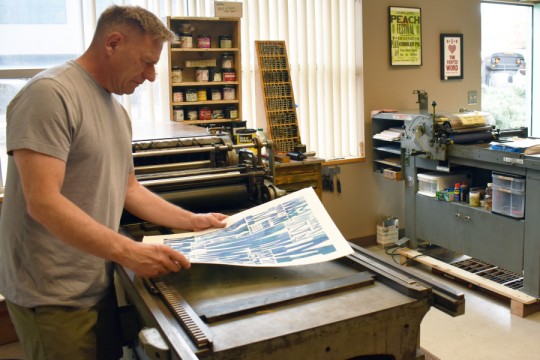 Steve Matteson working at a letterpress.