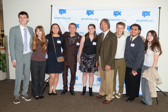 two men pose for a photo with students from the RIT in NYC program during the International Photographic Council’s luncheon at the United Nations