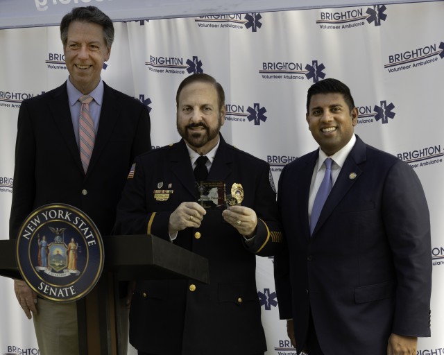 L to R:  Brighton Town Supervisor William Moehle, Senate Commendation Honoree Michael E. Pollock and NYS Senator Jeremy A. Cooney at ceremony held at Brighton Volunteer Ambulance base. (Photo by Emma M. Pollock)