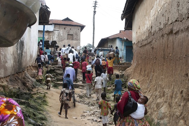 Bepoase, Ghana The community trods to the Village Center where the installation of an African American Queen Mother will take place in a four hour program known as a Durbar. From the “Queen Mother of Progress” Series.