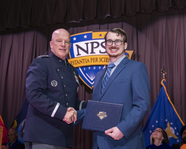 Michael Nixt (Right) is congratulated by guest speaker Gen. John W. 'Jay' Raymond (Left), the first Chief of Space Operations.