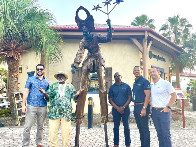 Executive staff and Sculptor Freeman from Island Global Yachting 'Mocko Jumbie Jamboree' unveiling