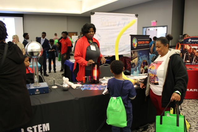 Tiffany performs an optics demonstration during a community STEM expo event.