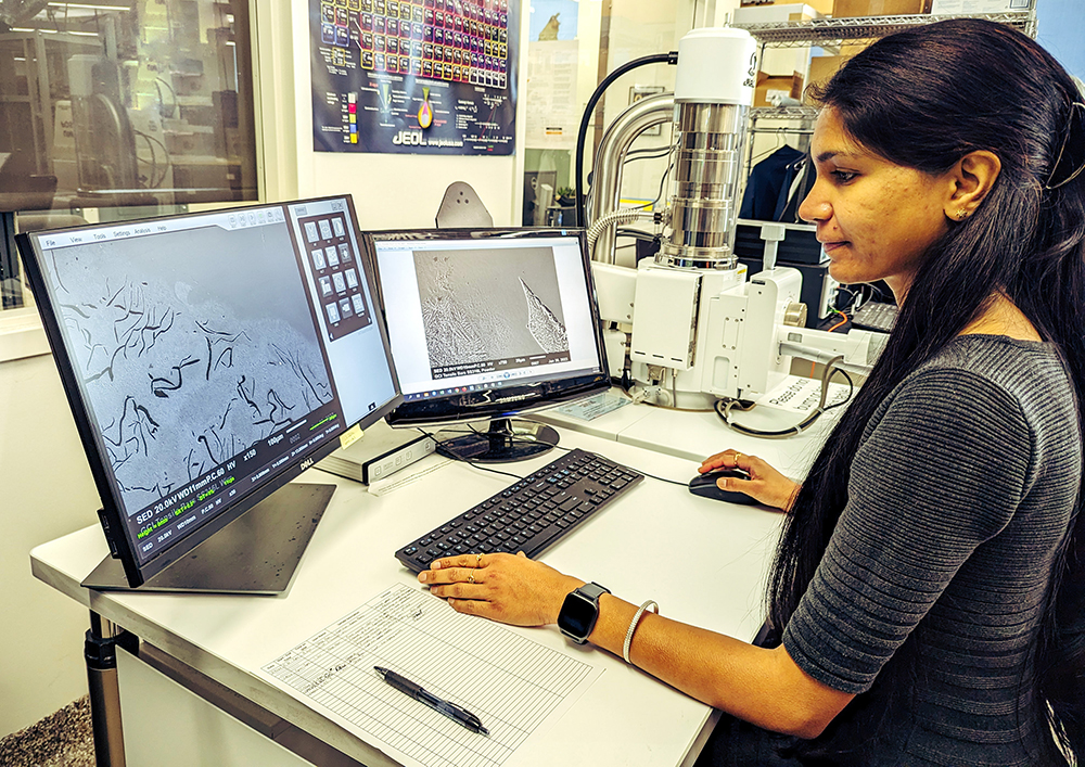 PhD Student Khushbu Zope uses a scanning electron microscope to inspect the microstructure of metal samples manufactured using the molten metal jetting (MMJ) additive process.