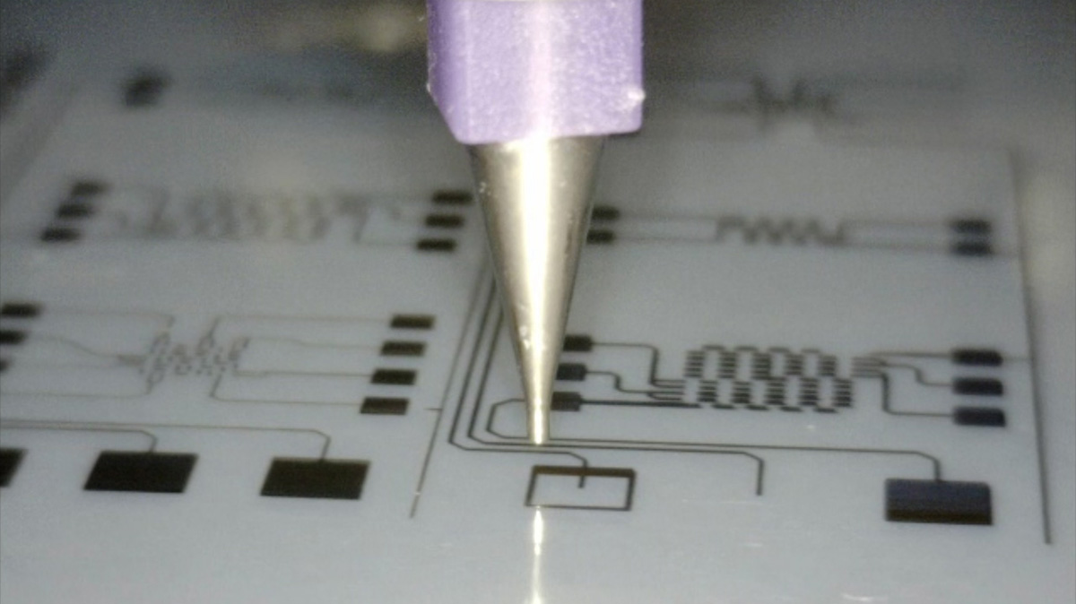 a nozzle prints connections onto a circuit board.