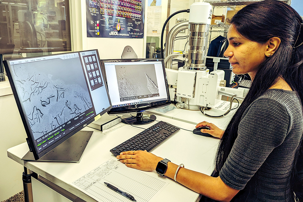 PhD Student Khushbu Zope uses a scanning electron microscope to inspect the microstructure of metal samples manufactured using the metal droplet jetting additive process.  