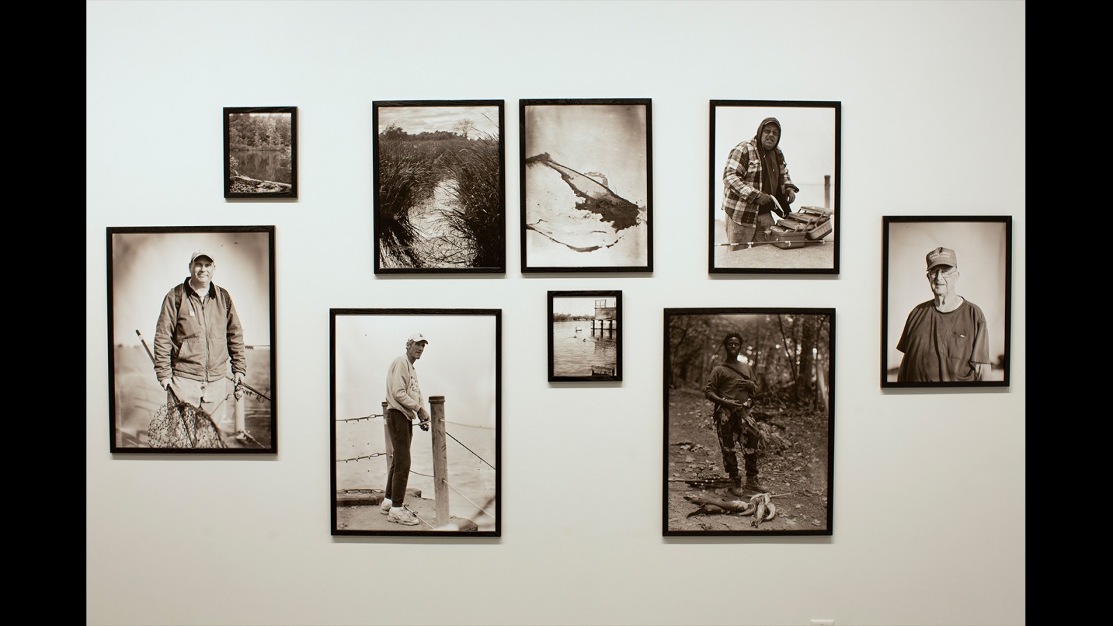 An array of black-and-white photos on a wall.