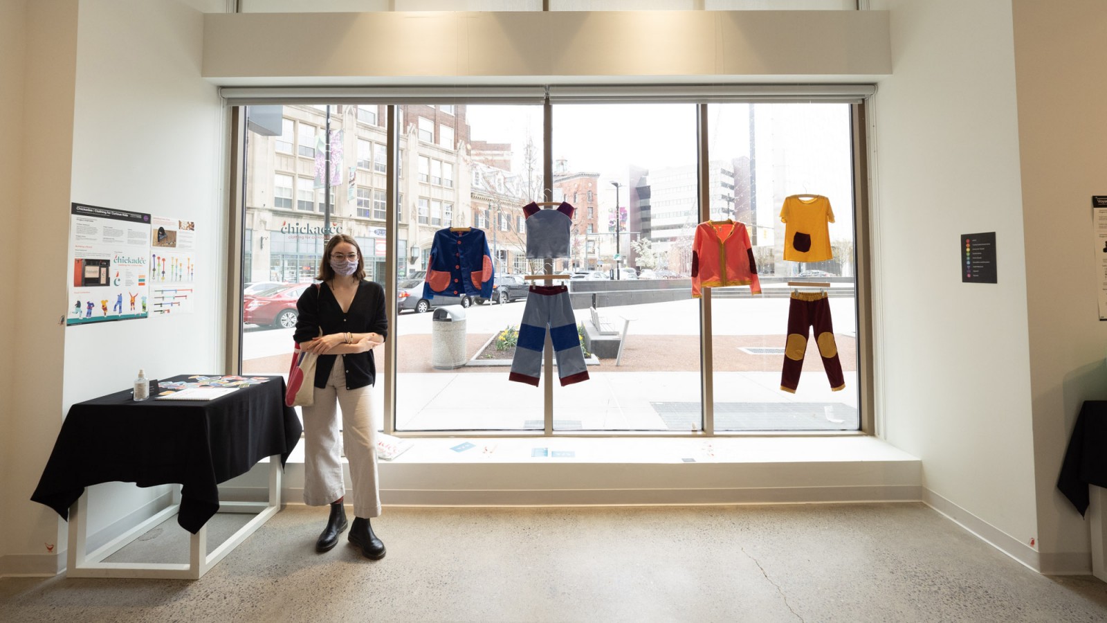 Industrial Design student Daeya Shealy poses in front of her display of sustainable clothing line.