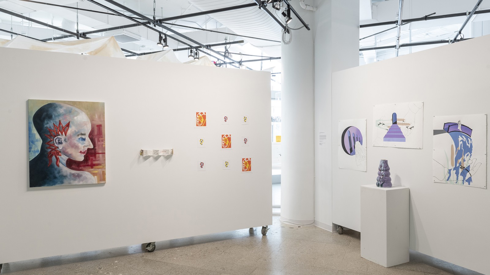 Paintings are displayed on walls in RIT City Art Space.