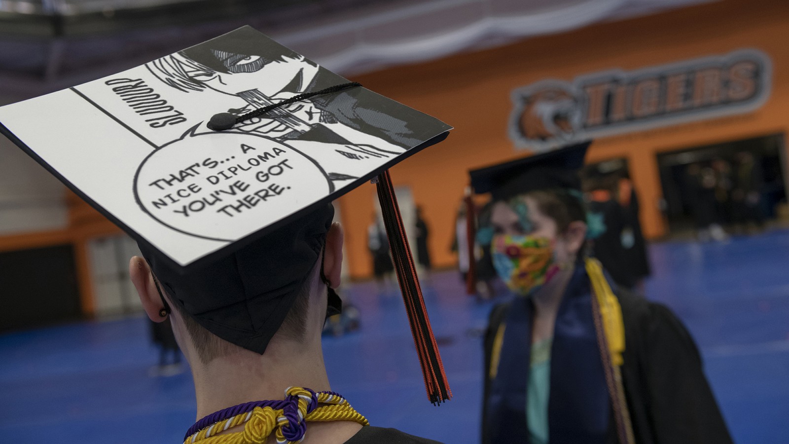 A grad cap with a comic book illustration.