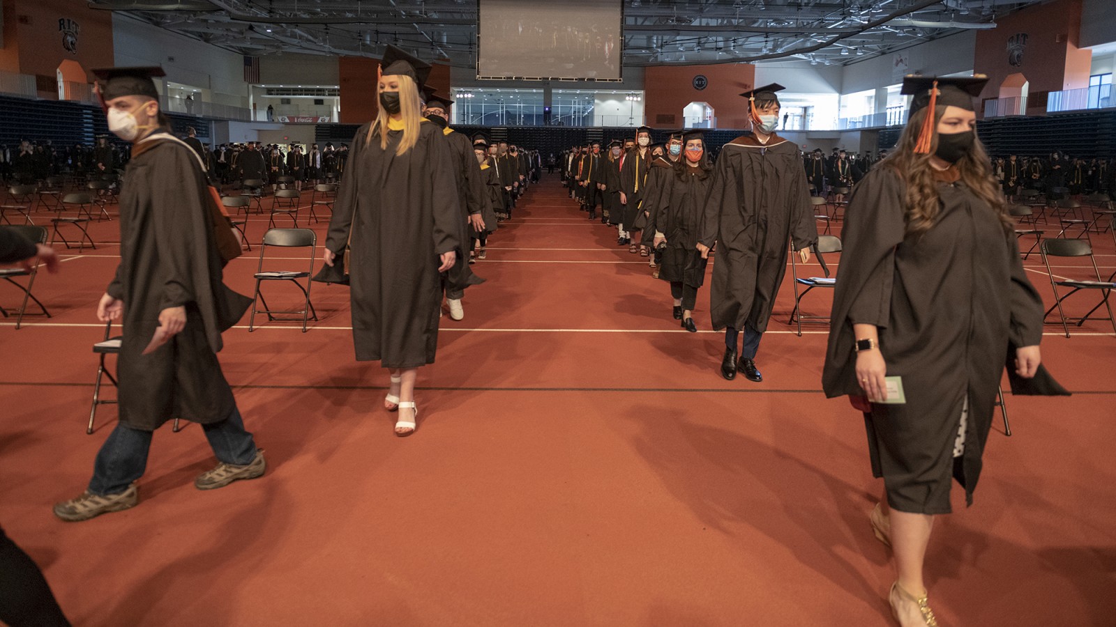 A line of students walk down the aisle at Commencement.