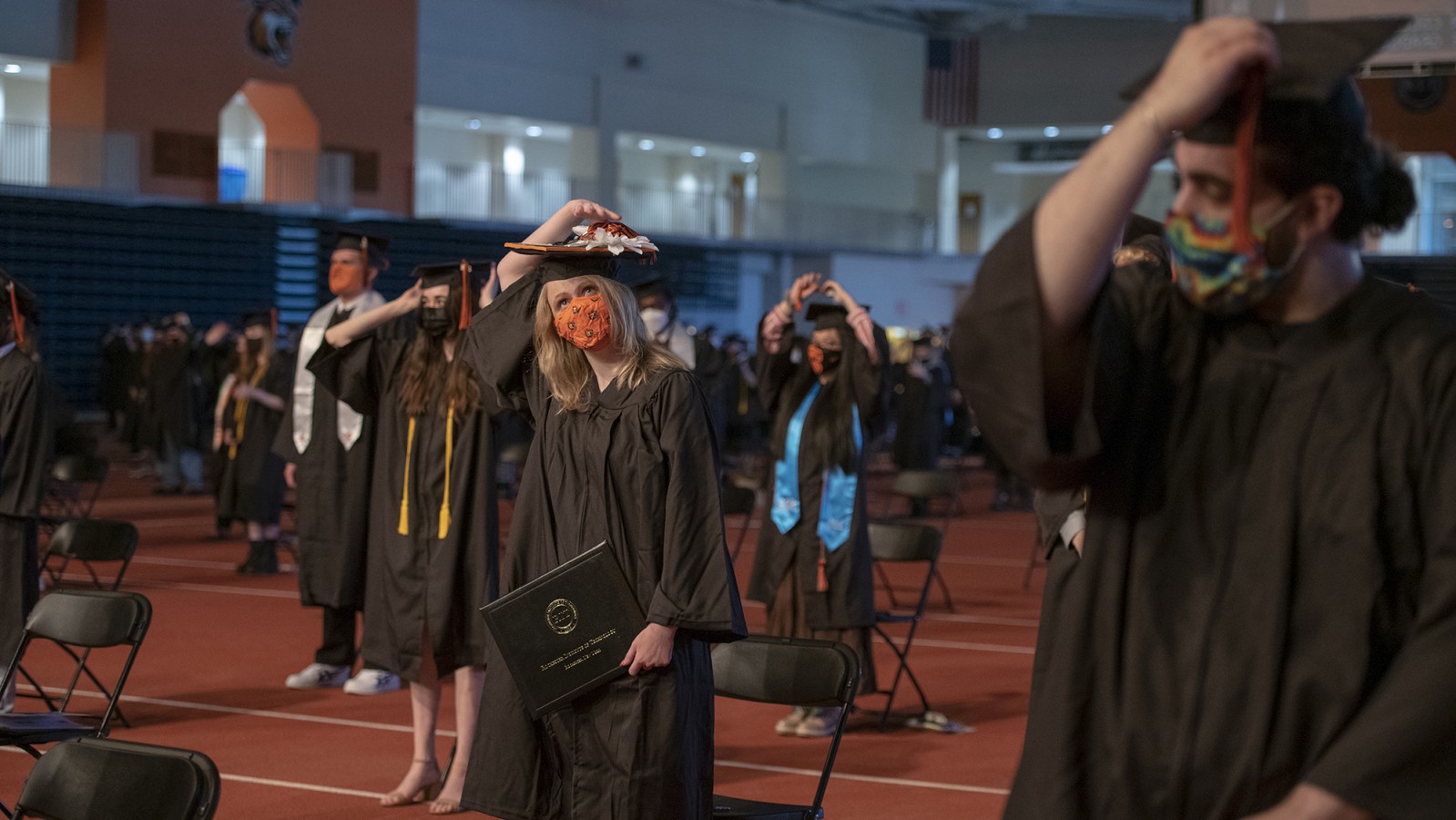 Graduate candidates flip their tassels to the other side of their grad caps.