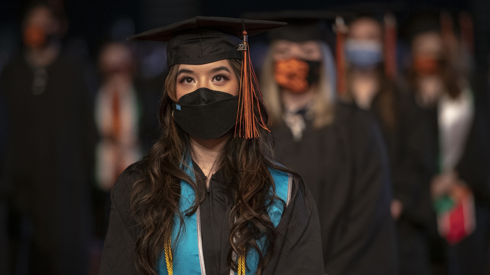 A student wears a mask during the Commencement ceremony.