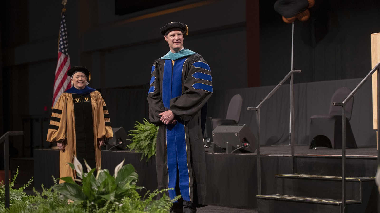 Dean Todd Jokl stands on stage next to Provost Ellen Granberg.