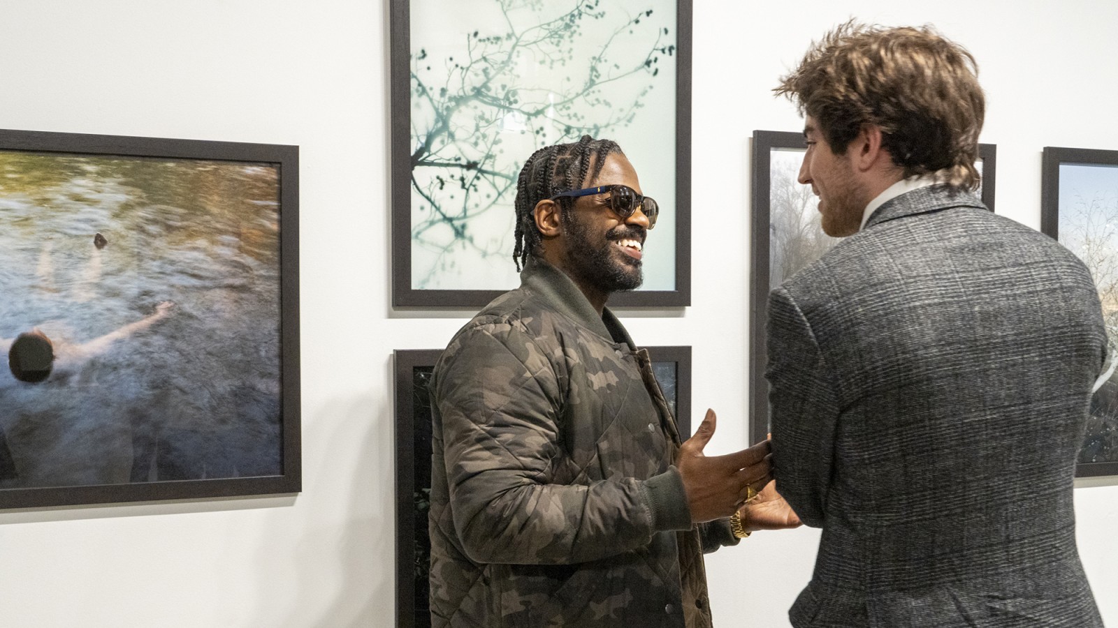 Two people talk in RIT City Art Space.