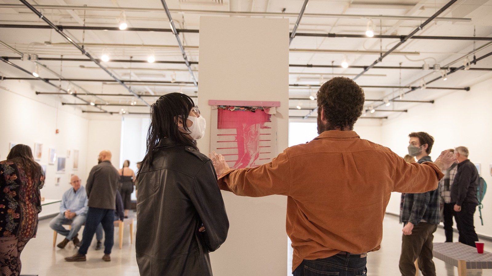 Gallery visitors look at photos on walls in William Harris Gallery.