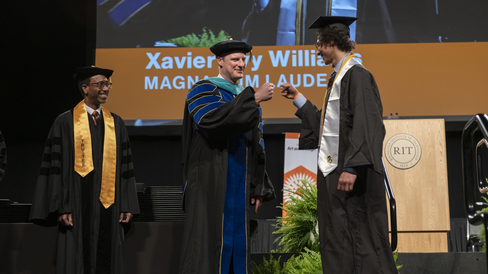 Dean Todd Jokl confers a degree to a student.