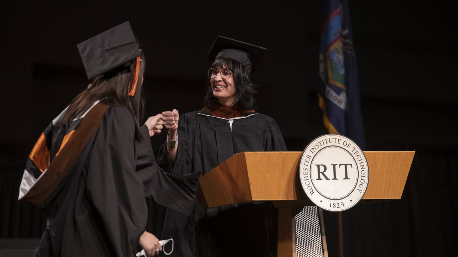 School of Film and Animation Director Shanti Thakur fist bumps a student.