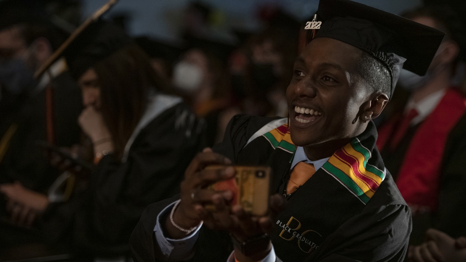 A student in the crowd smiles wide.