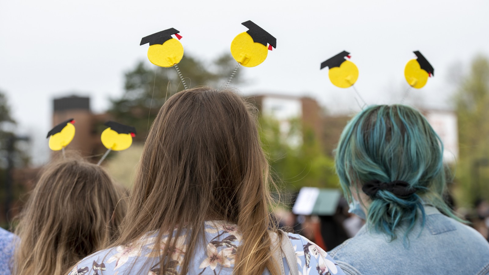 People wearing homemade headsets with pacmen-looking people wearing grad caps.