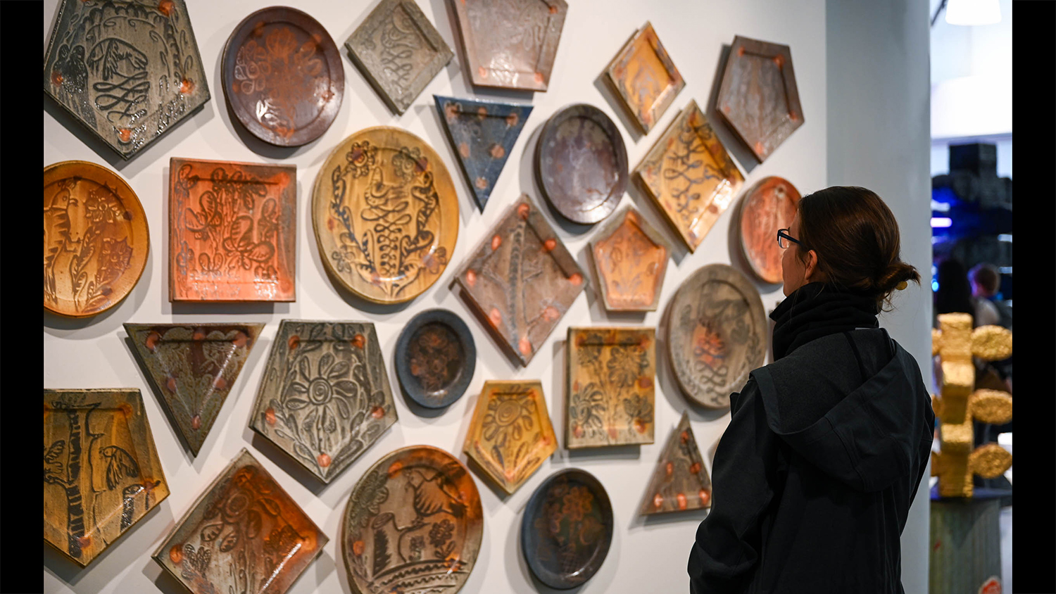 Ceramic platters on a gallery wall inside City Art Space.