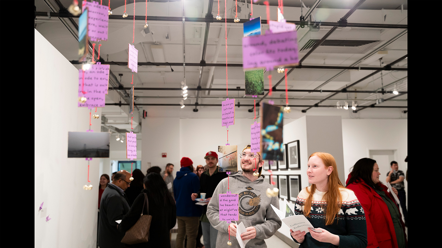 A crowded William Harris Gallery views a capstone exhibition.