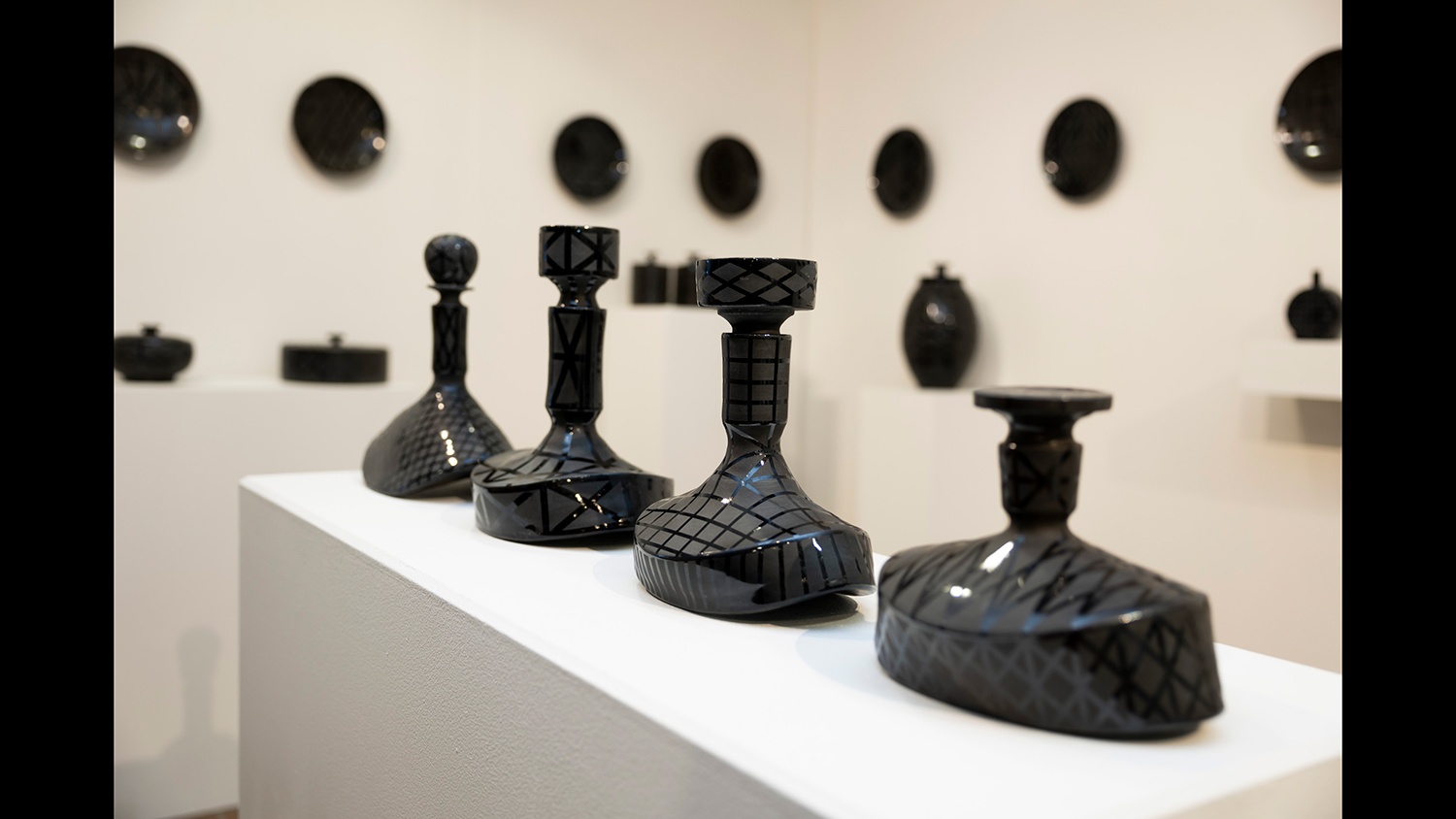 Ceramic vessels sit on a pedestal.